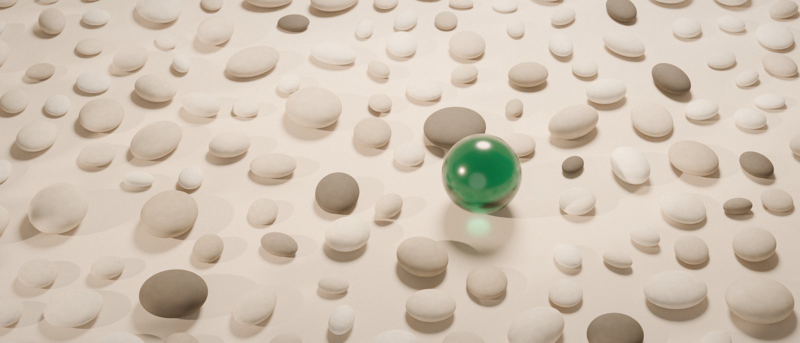 Seen from above: a field of pale stones, and one emerald glass sphere.
